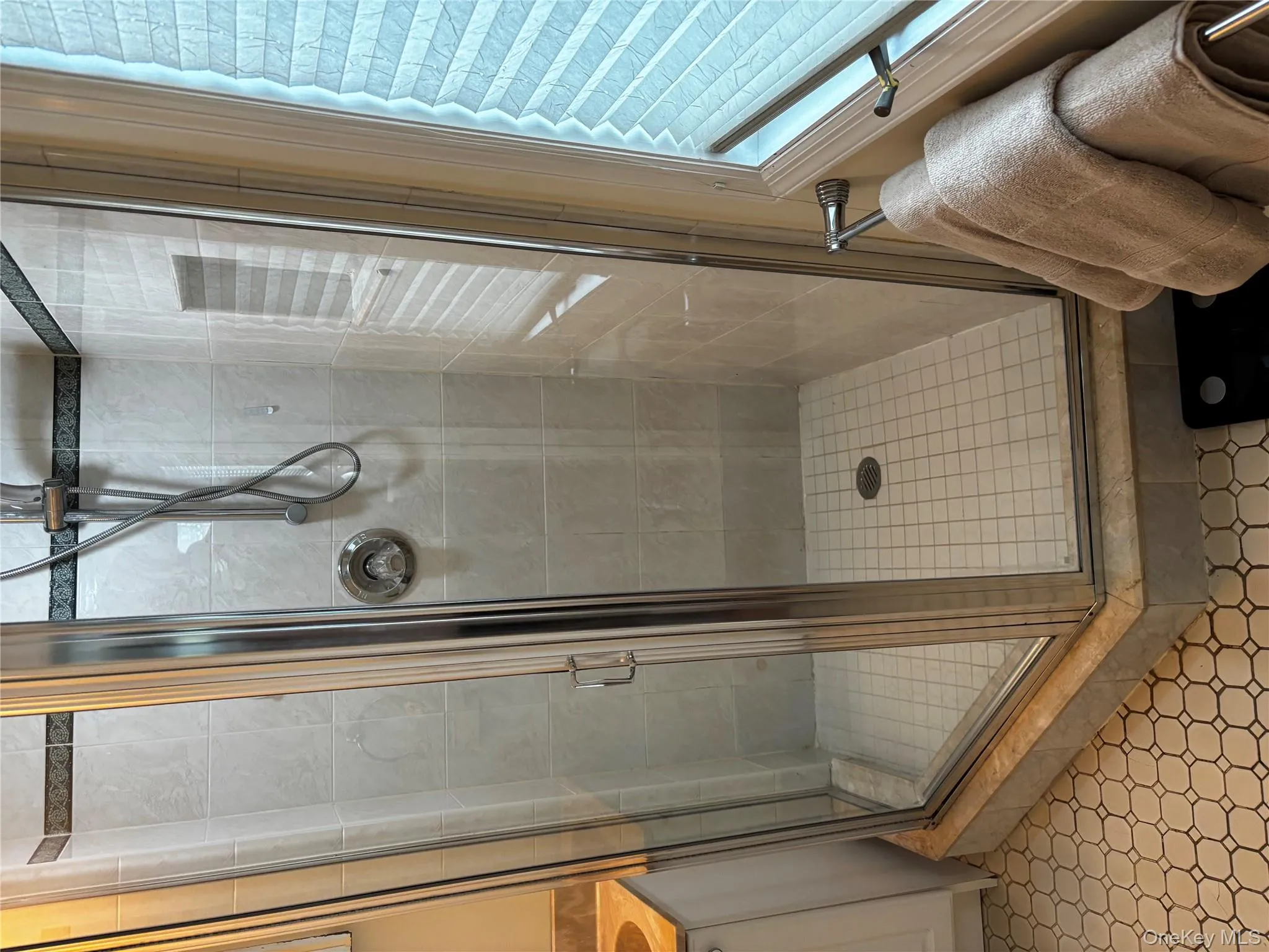 Bathroom featuring a shower stall and vanity Bathroom featuring a shower stall and vanity