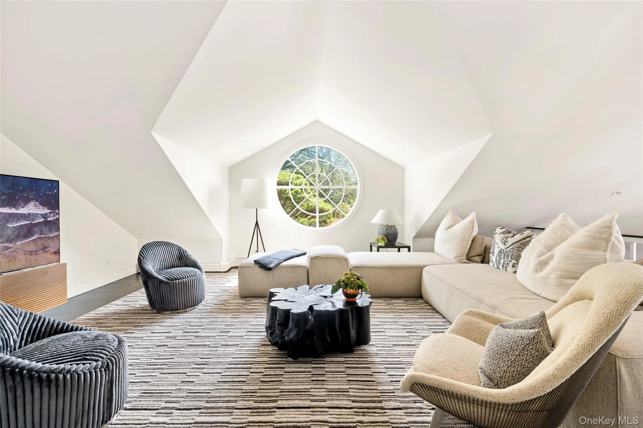 Second Floor Media_Living area with vaulted ceiling and wood finished floors Second Floor Media_Living area with vaulted ceiling and wood finished floors