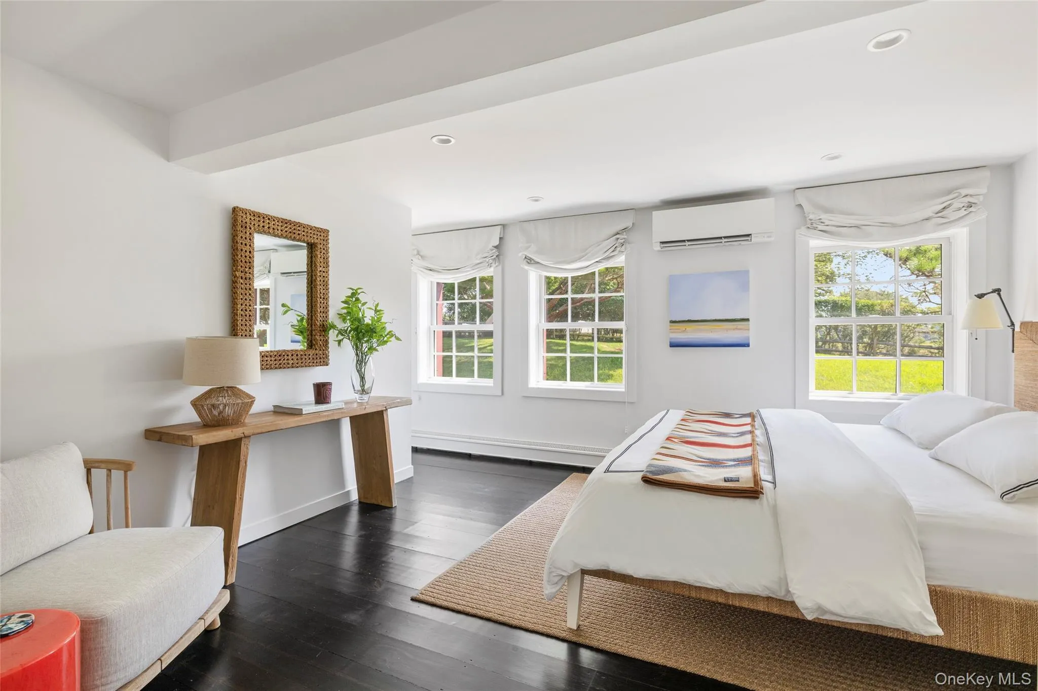 1st Floor Bedroom featuring multiple windows, dark wood-type flooring, a wall unit AC, recessed lighting, and a baseboard radiator 1st Floor Bedroom featuring multiple windows, dark wood-type flooring, a wall unit AC, recessed lighting, and a baseboard radiator