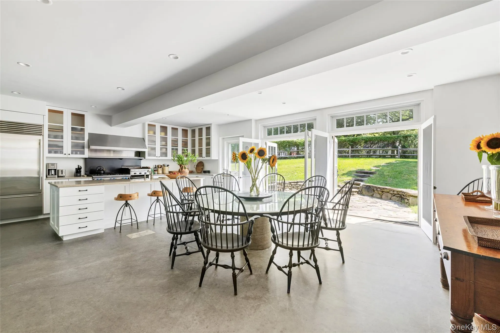 Dining space featuring concrete flooring and recessed lighting Dining space featuring concrete flooring and recessed lighting