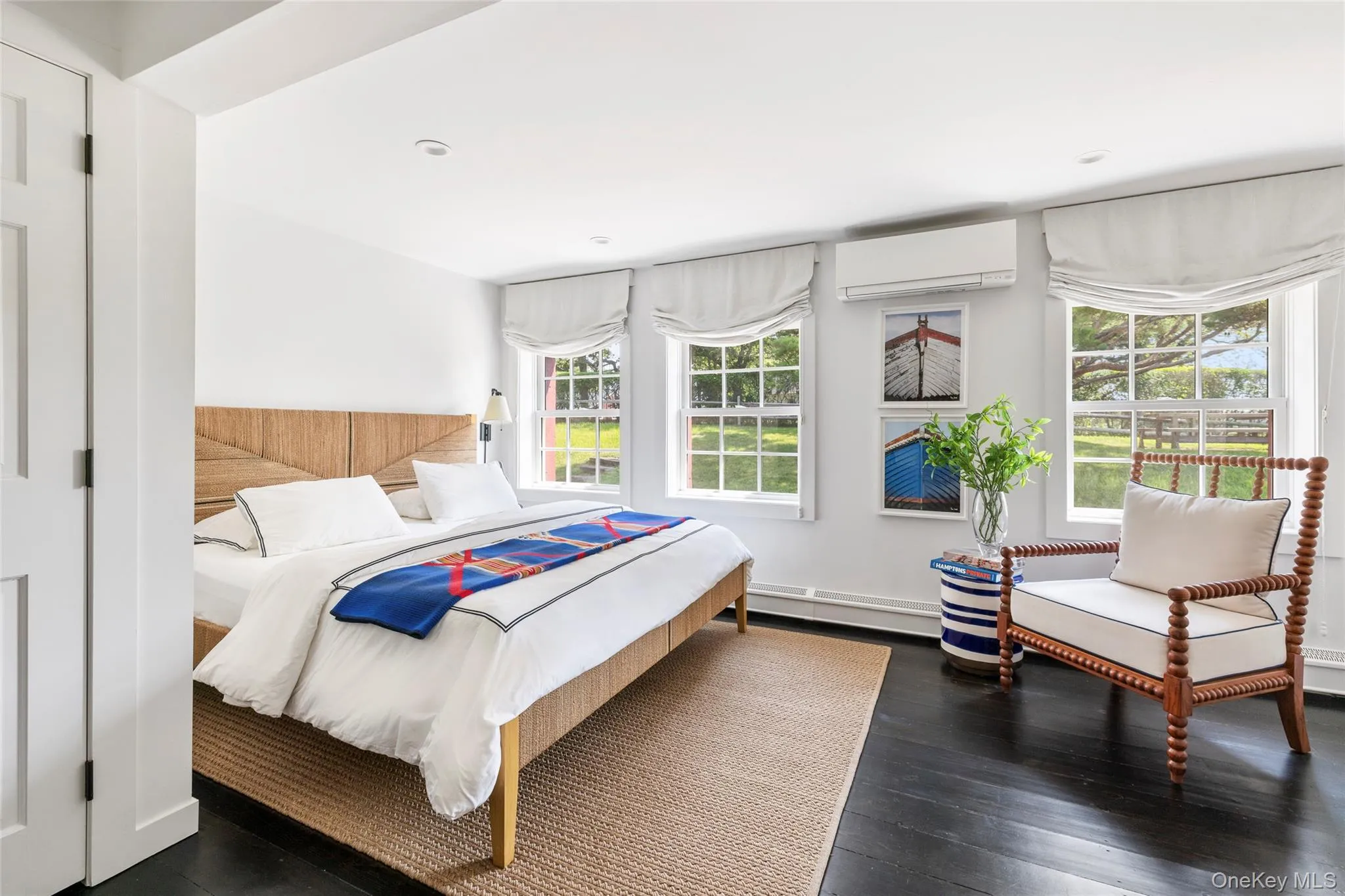 1st Bedroom Ensuite featuring dark wood-type flooring, an AC wall unit, recessed lighting, and baseboard heating 1st Bedroom Ensuite featuring dark wood-type flooring, an AC wall unit, recessed lighting, and baseboard heating