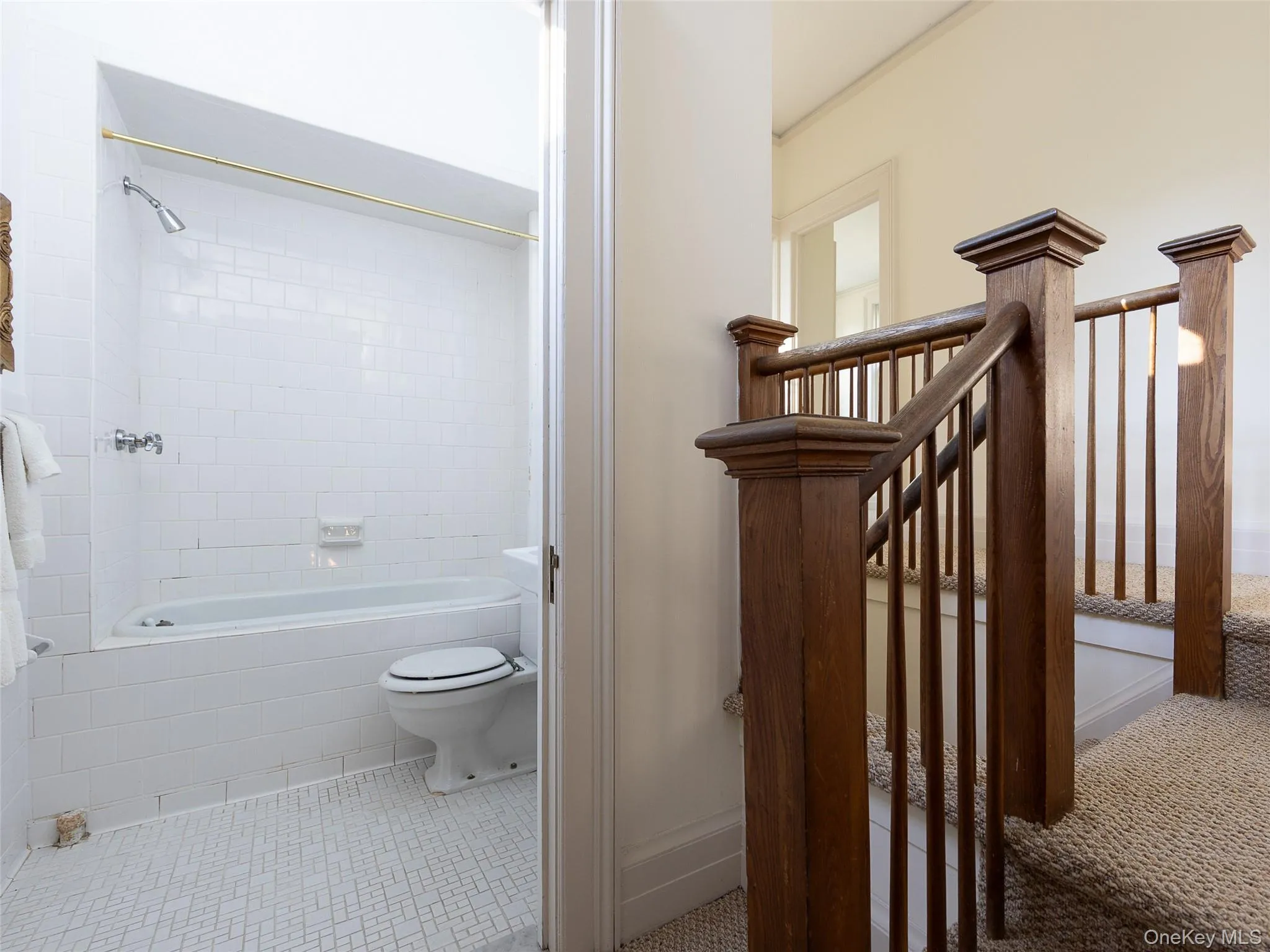 Full bathroom with tiled shower / bath combo and light tile patterned floors Full bathroom with tiled shower / bath combo and light tile patterned floors