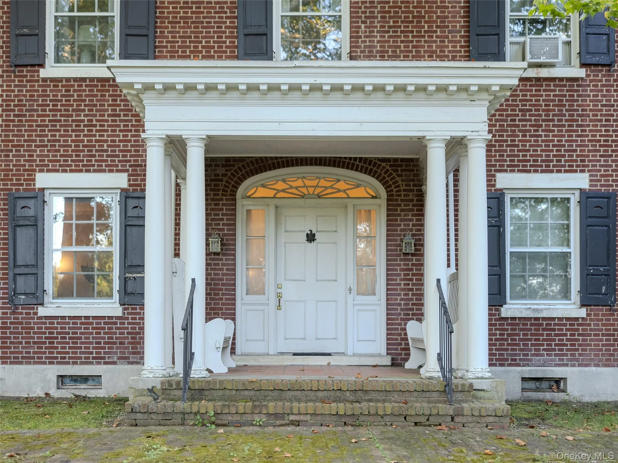 Entrance to property featuring brick siding and covered porch Entrance to property featuring brick siding and covered porch