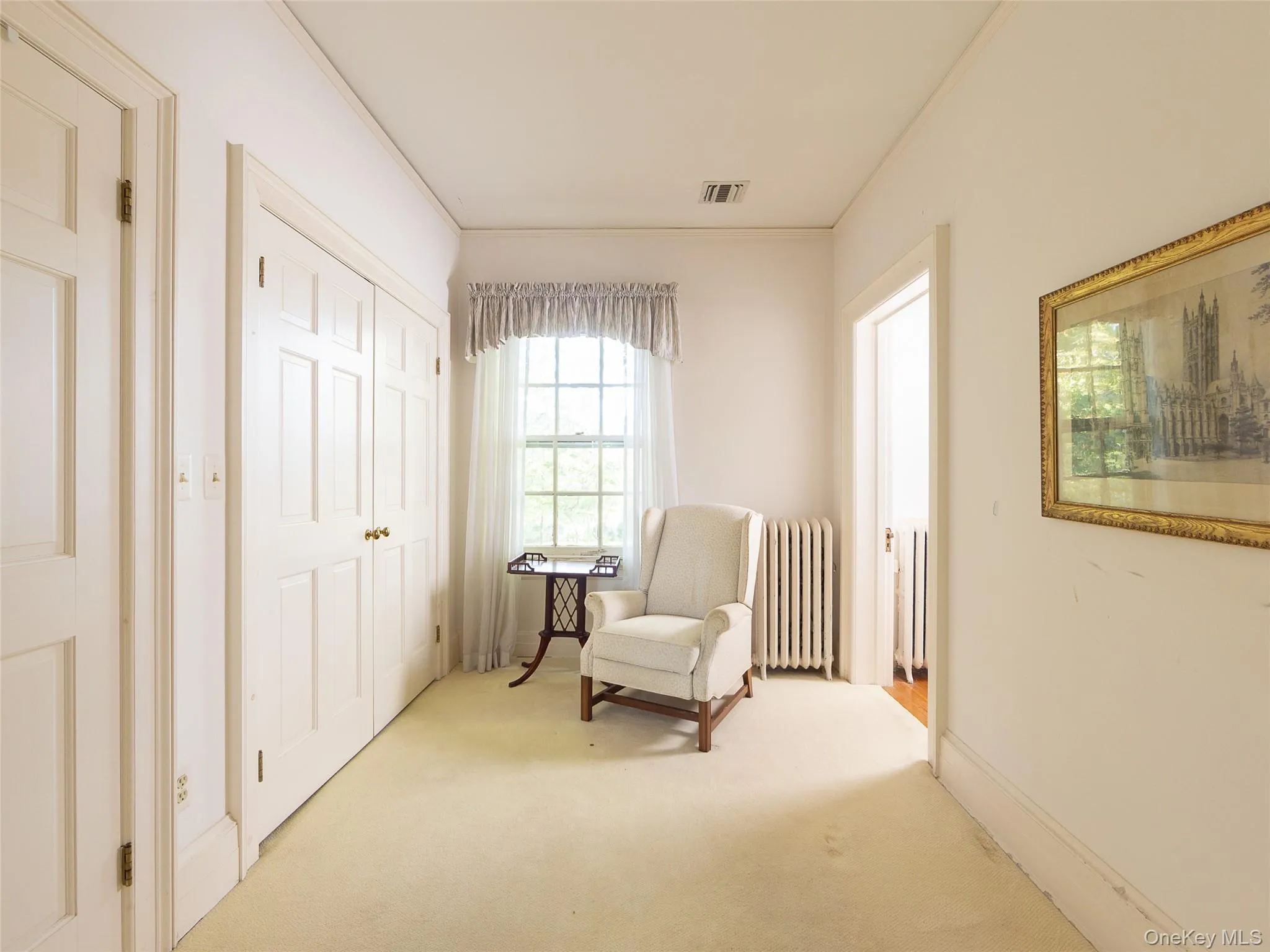 Sitting room with radiator, carpet, and crown molding Sitting room with radiator, carpet, and crown molding