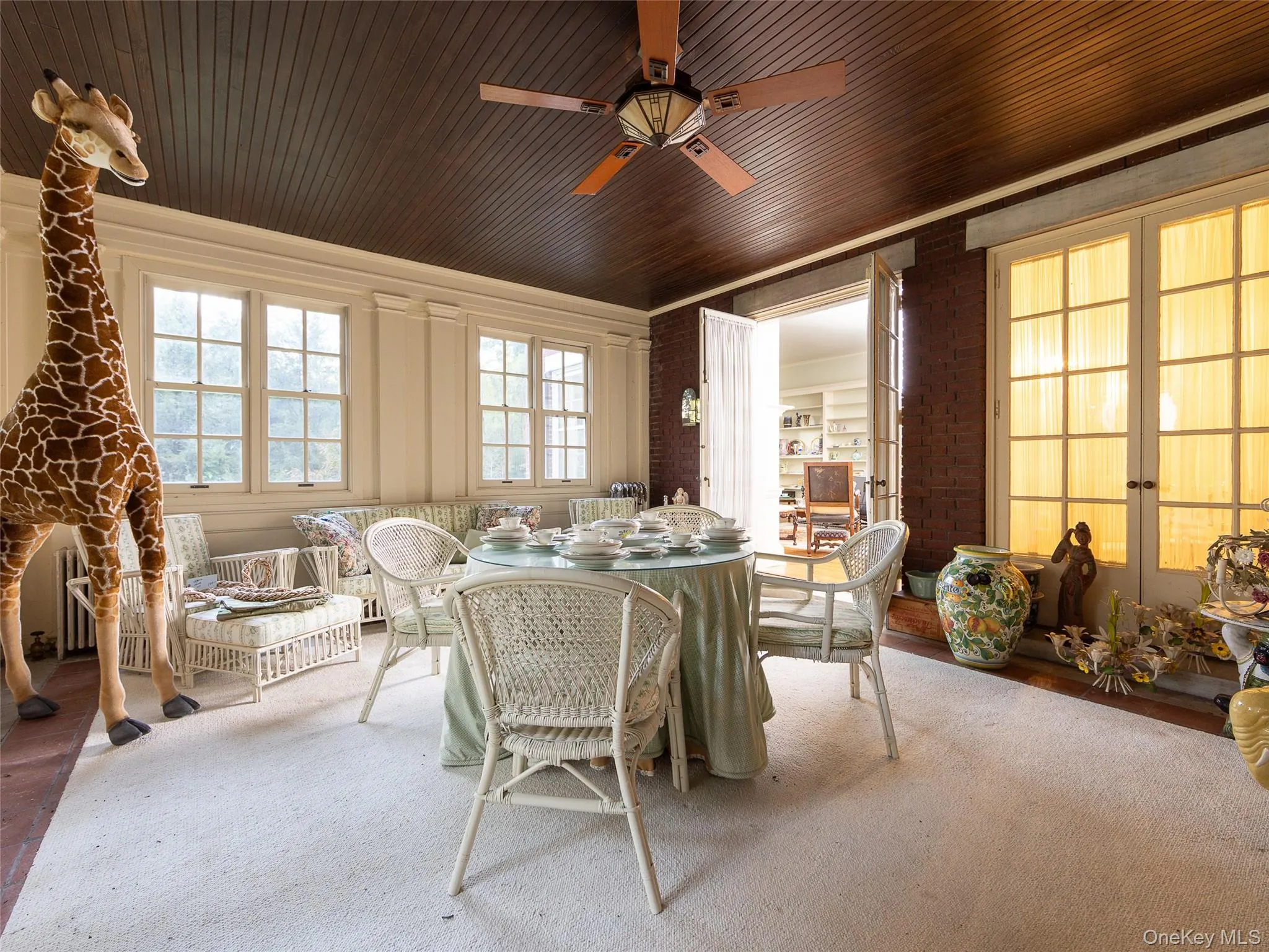 Dining area with ceiling fan and brick wall Dining area with ceiling fan and brick wall
