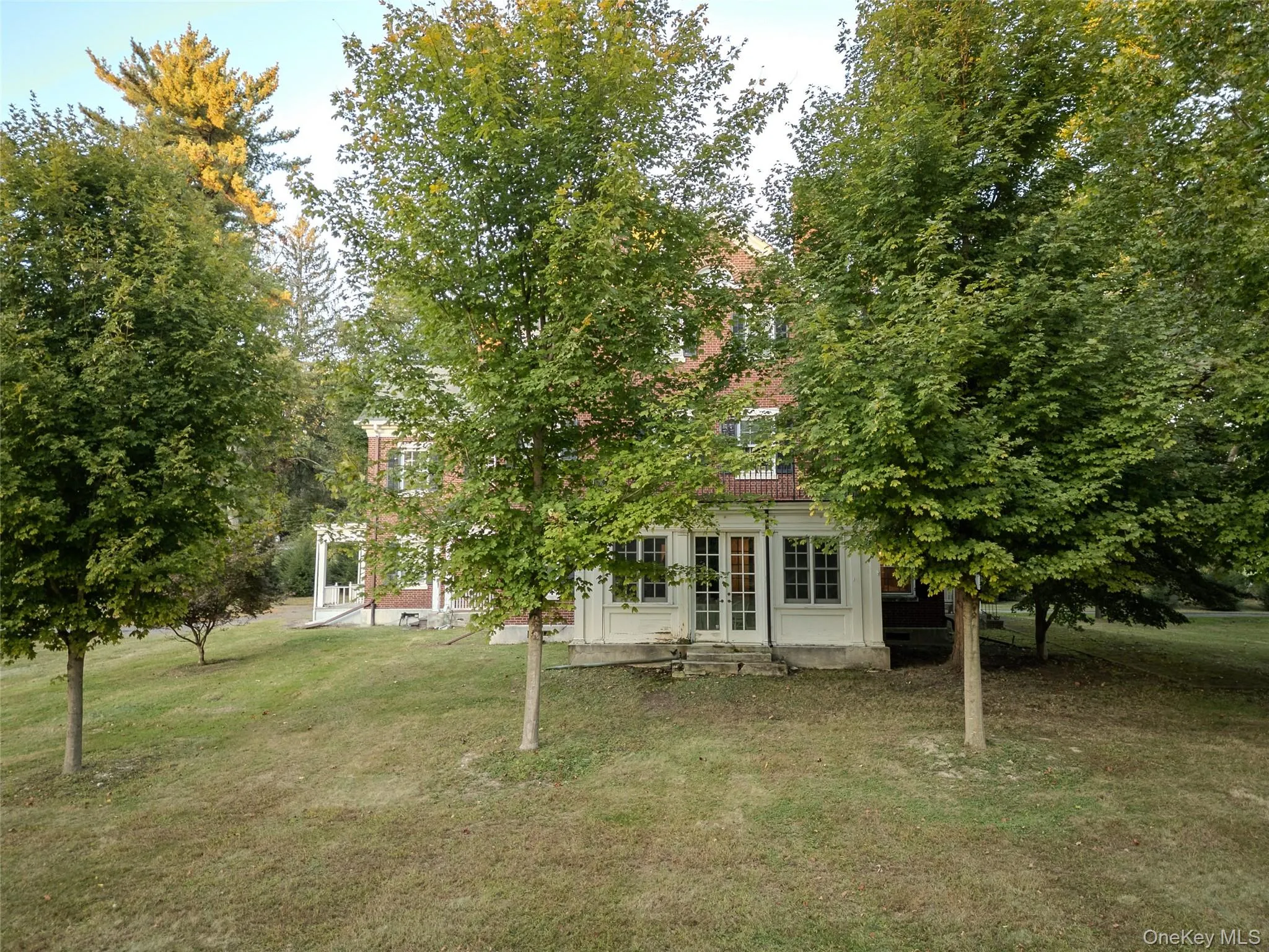 View of grassy yard featuring french doors View of grassy yard featuring french doors