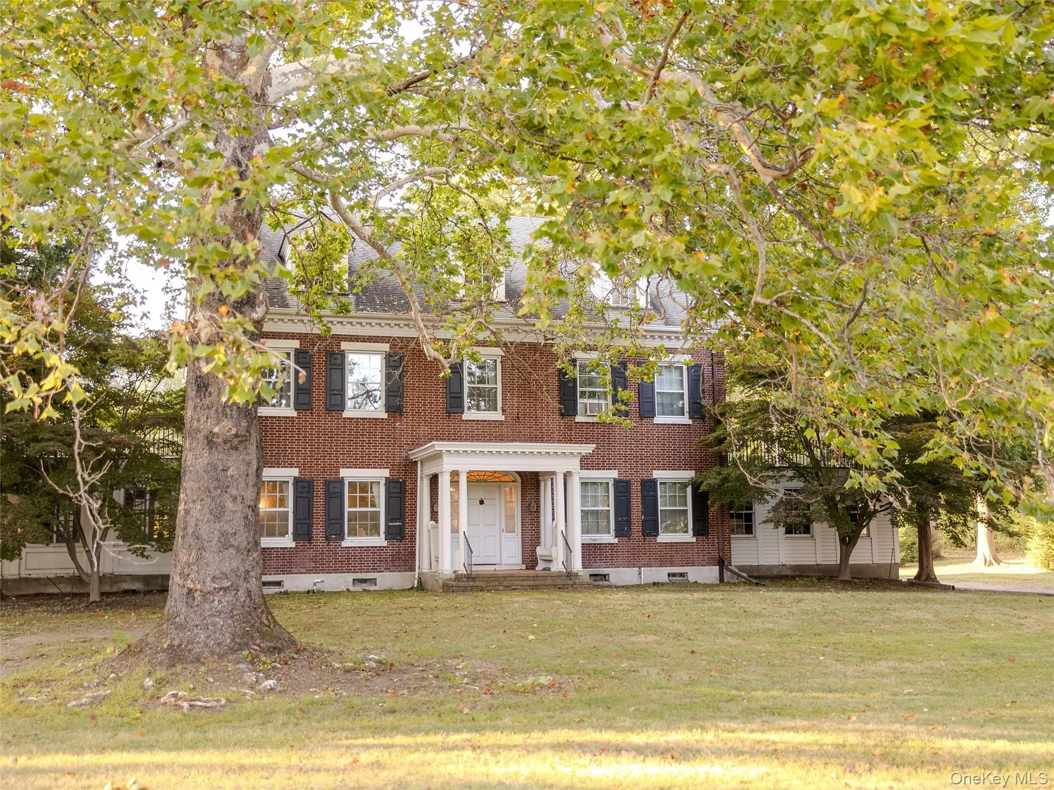Colonial inspired home with brick siding, a front lawn, and crawl space Colonial inspired home with brick siding, a front lawn, and crawl space