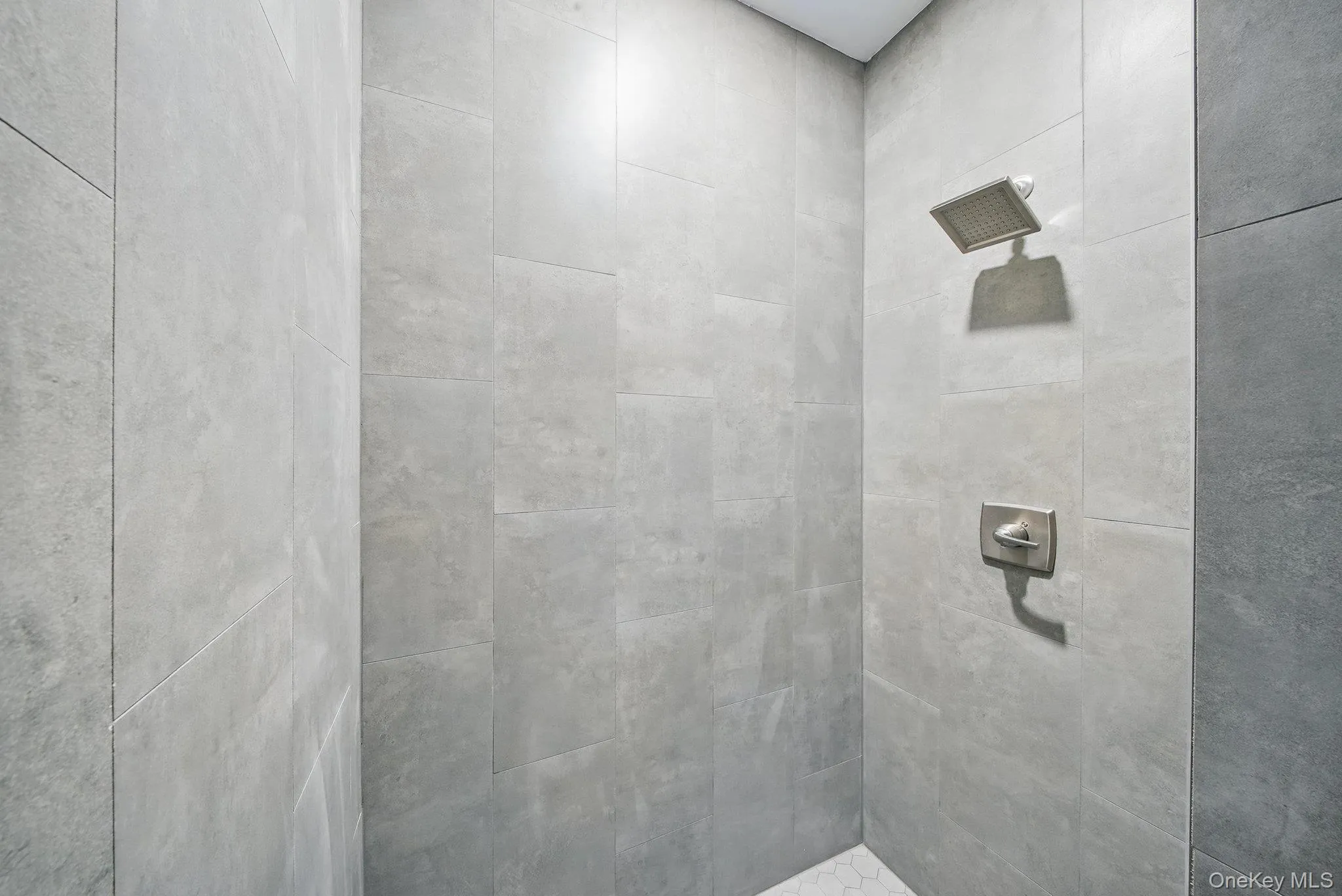 Full bathroom featuring a tile shower Full bathroom featuring a tile shower