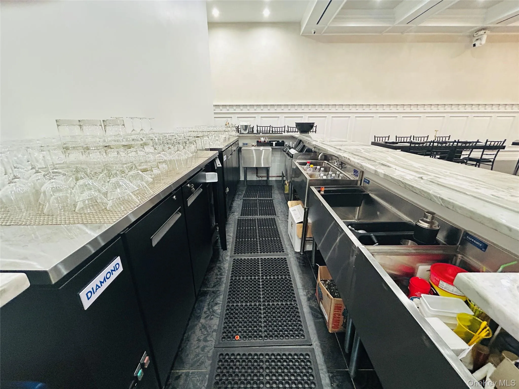 Kitchen with dark cabinetry, stainless steel counters, and recessed lighting Kitchen with dark cabinetry, stainless steel counters, and recessed lighting