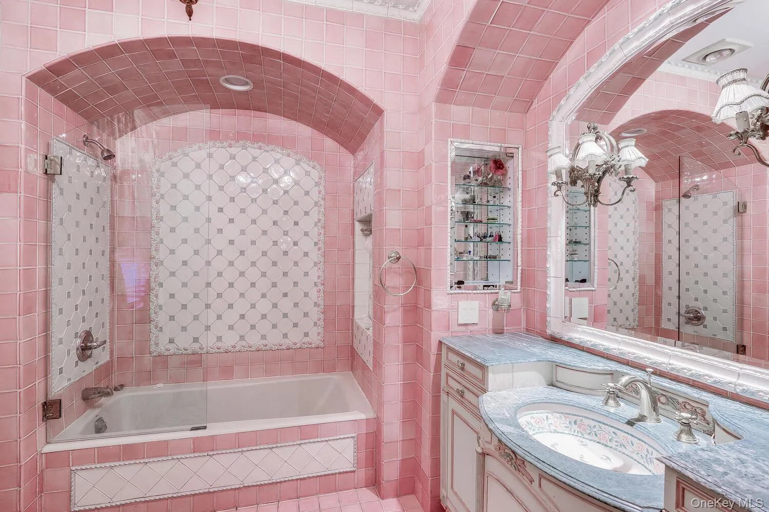 Full bath featuring tile walls, vanity, and tiled shower / bath combo Full bath featuring tile walls, vanity, and tiled shower / bath combo