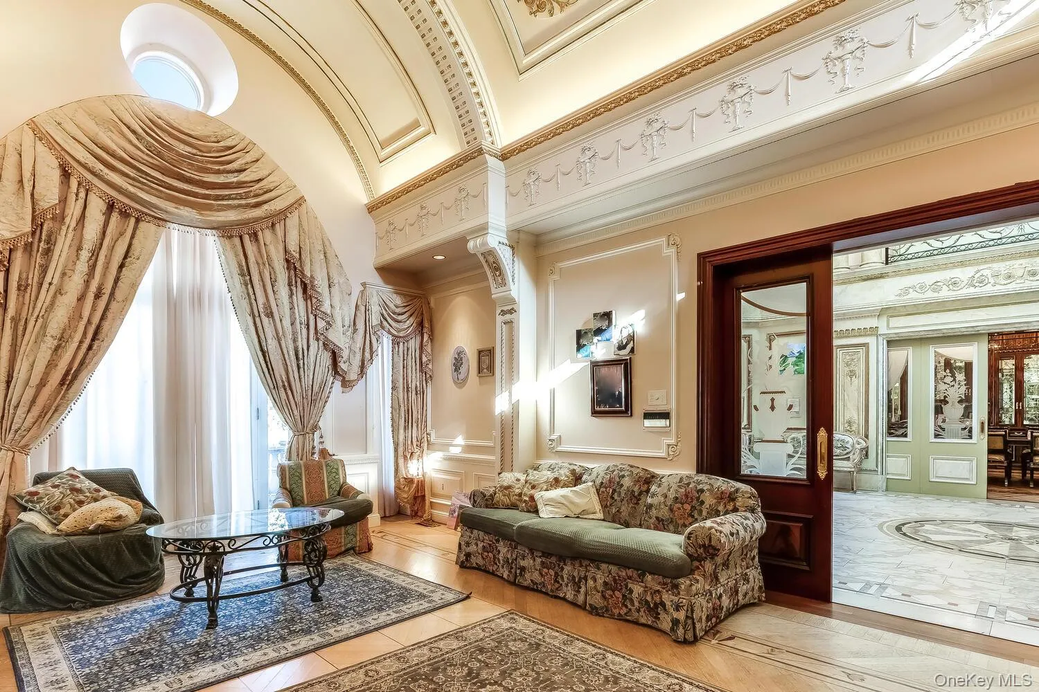 Community lobby featuring a decorative wall, crown molding, and a wainscoted wall Community lobby featuring a decorative wall, crown molding, and a wainscoted wall