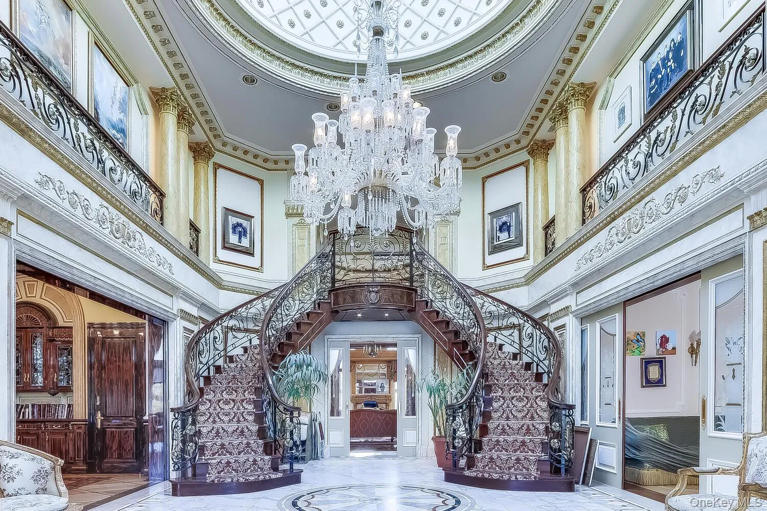 Building lobby featuring a high ceiling, ornamental molding, and stairs Building lobby featuring a high ceiling, ornamental molding, and stairs