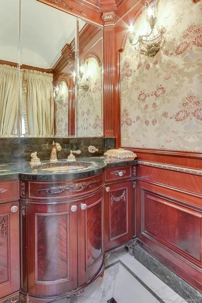 Bathroom with vanity and wallpapered walls Bathroom with vanity and wallpapered walls