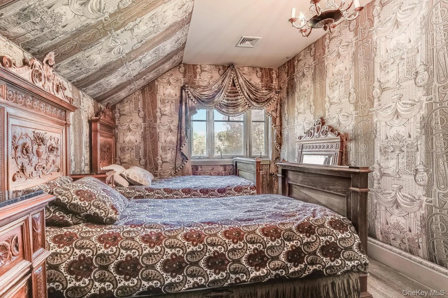 Bedroom featuring wallpapered walls, lofted ceiling, and wood finished floors Bedroom featuring wallpapered walls, lofted ceiling, and wood finished floors
