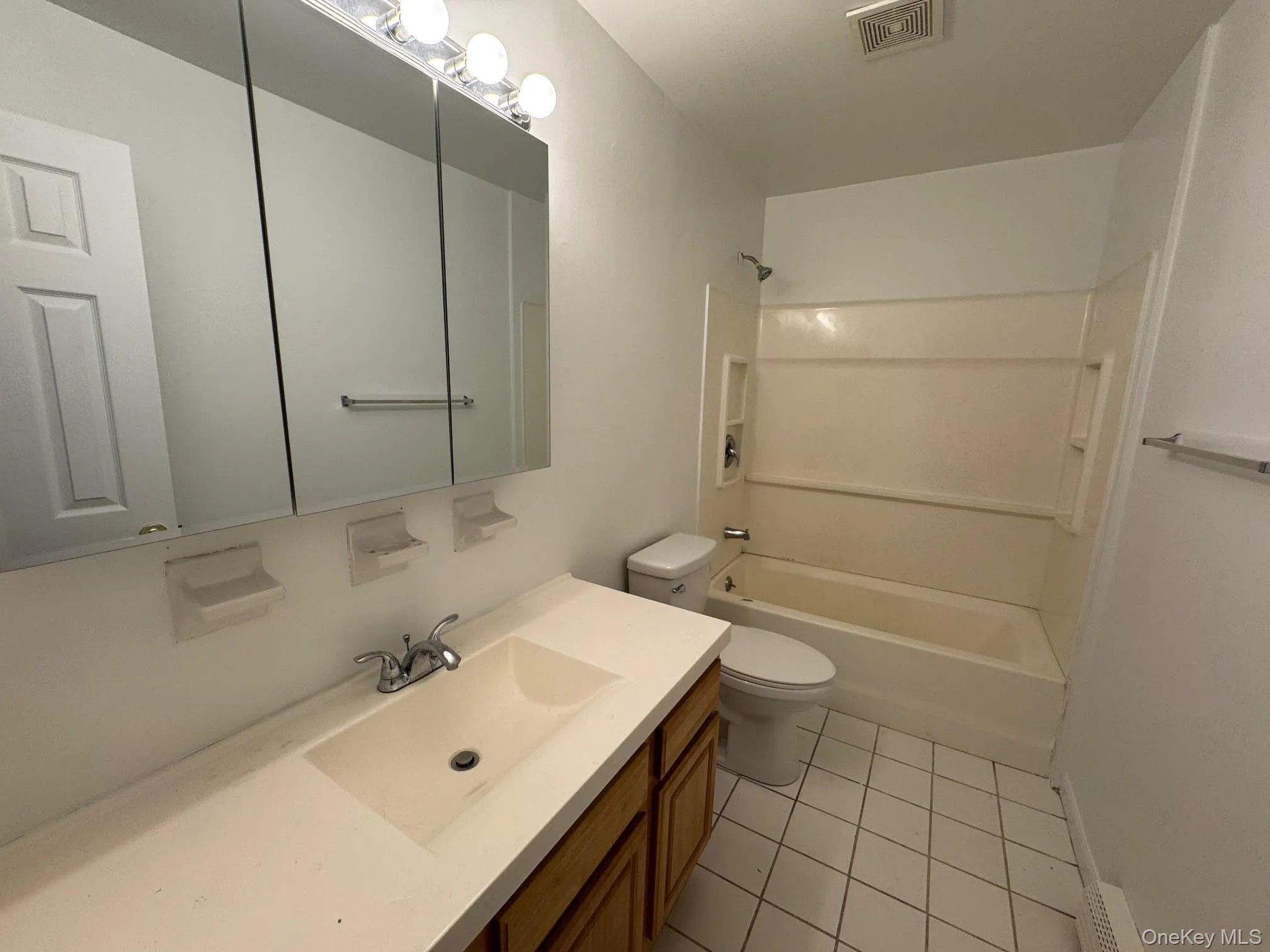 Bathroom with light tile patterned floors, shower combination, and vanity Bathroom with light tile patterned floors, shower combination, and vanity