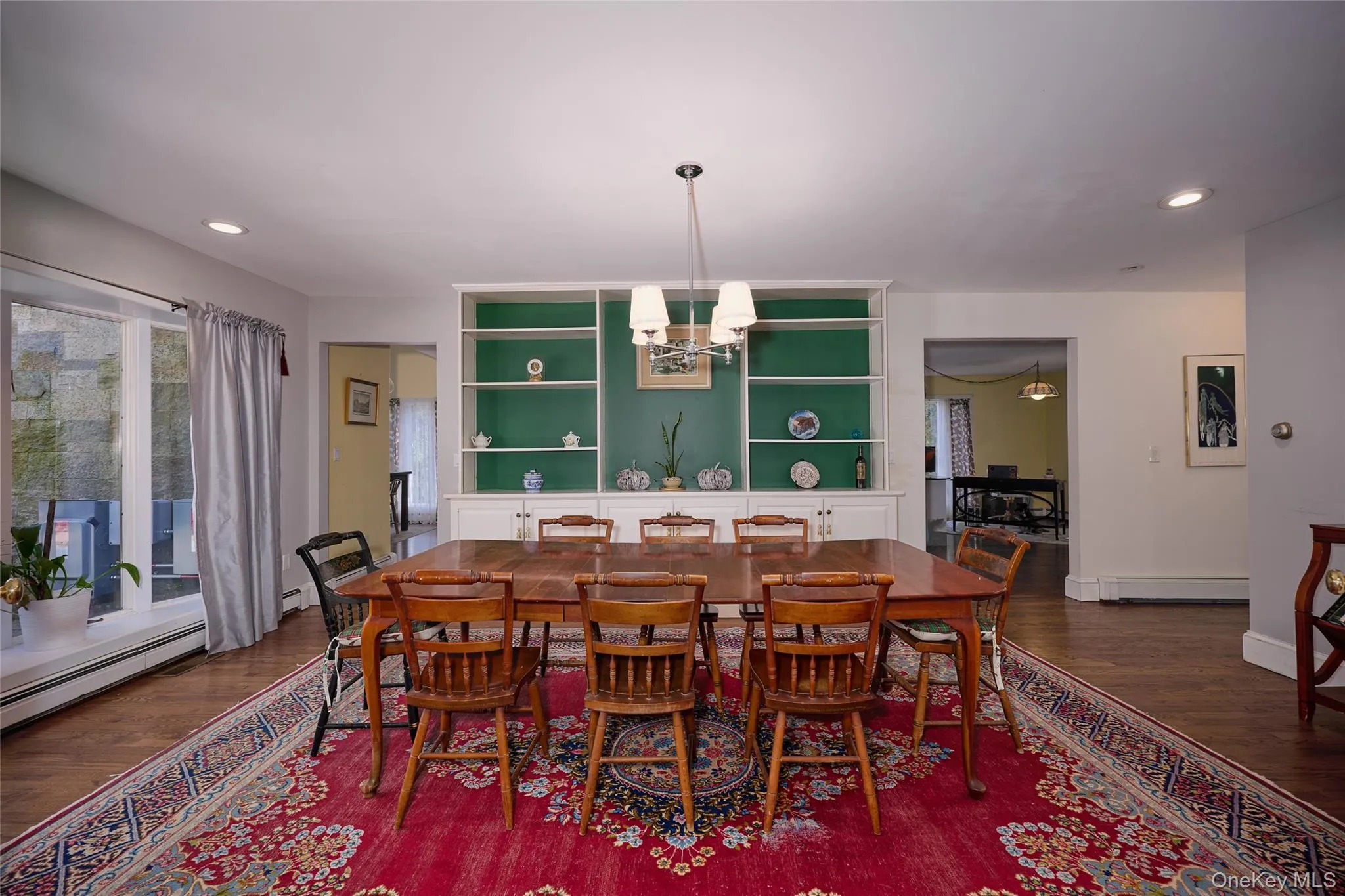 Dining room with recessed lighting, a chandelier, and dark wood-style flooring Dining room with recessed lighting, a chandelier, and dark wood-style flooring