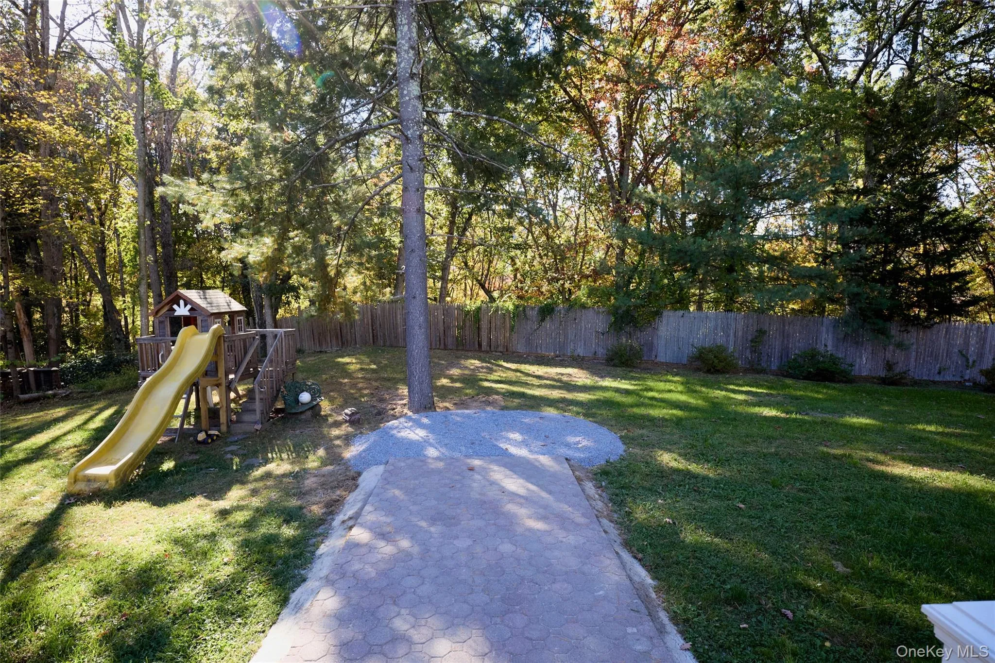 Fenced backyard featuring a playground Fenced backyard featuring a playground