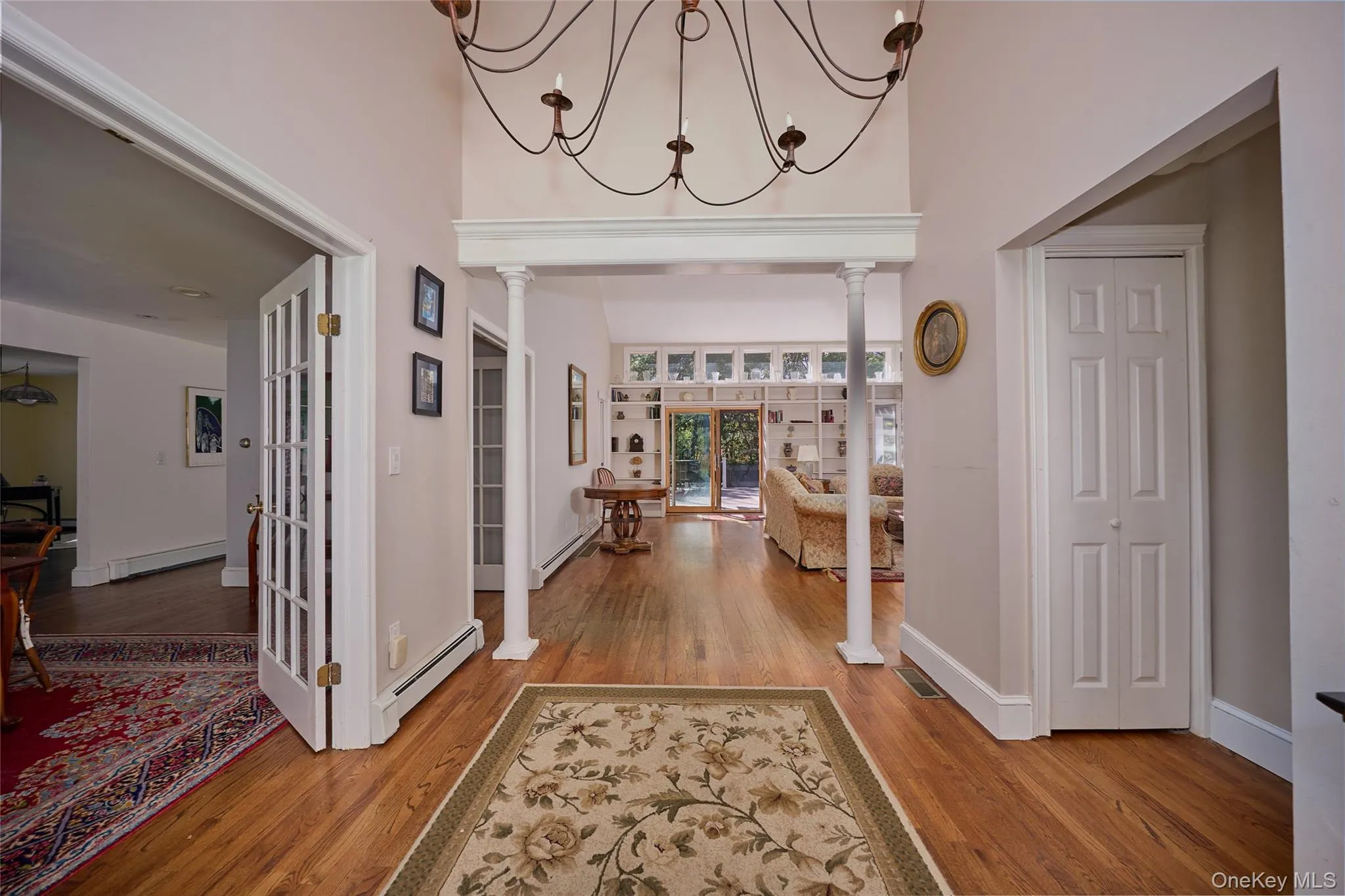Foyer entrance open and inviting, wood finished floors, and a towering ceiling Foyer entrance open and inviting, wood finished floors, and a towering ceiling