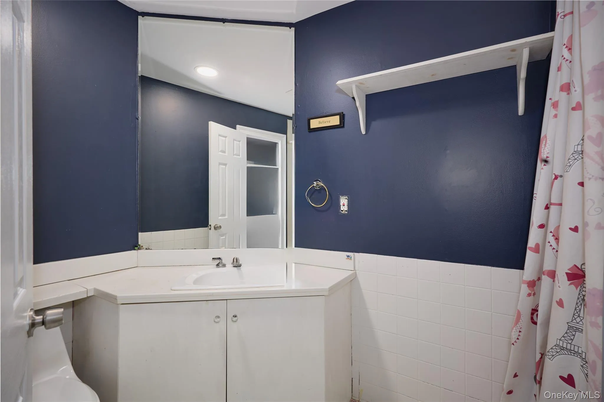 Full bath off 3rd bedroom featuring vanity and tile walls Full bath off 3rd bedroom featuring vanity and tile walls