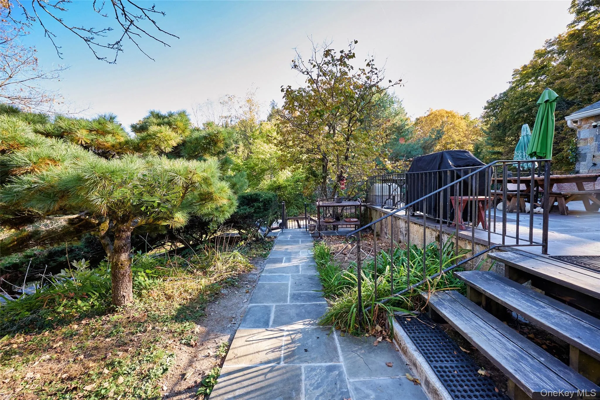 View of side of Patio with outdoor dining space and a deck View of side of Patio with outdoor dining space and a deck