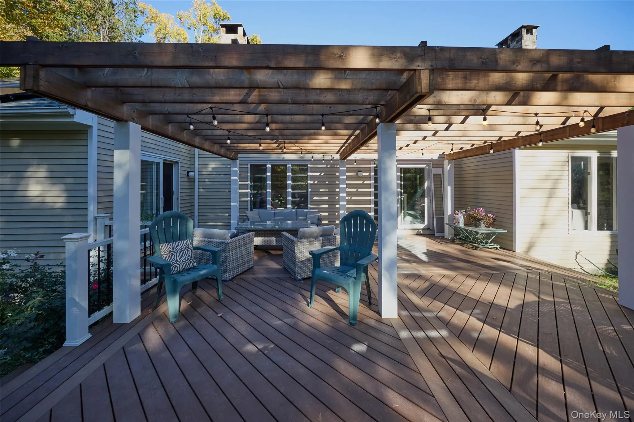 Trex deck with an outdoor hangout area and a pergola Trex deck with an outdoor hangout area and a pergola