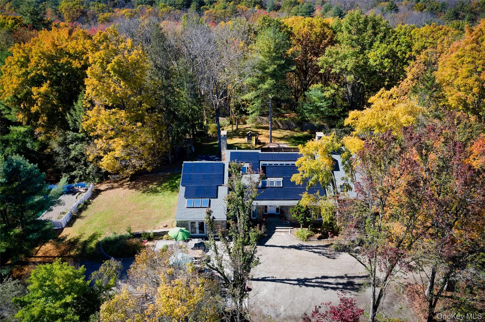 View from above of property with a heavily wooded area View from above of property with a heavily wooded area