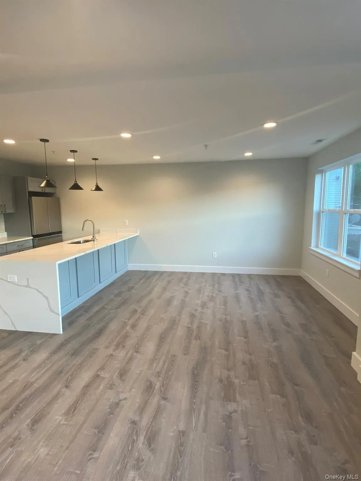 Unfurnished living room with recessed lighting and dark wood-style flooring Unfurnished living room with recessed lighting and dark wood-style flooring