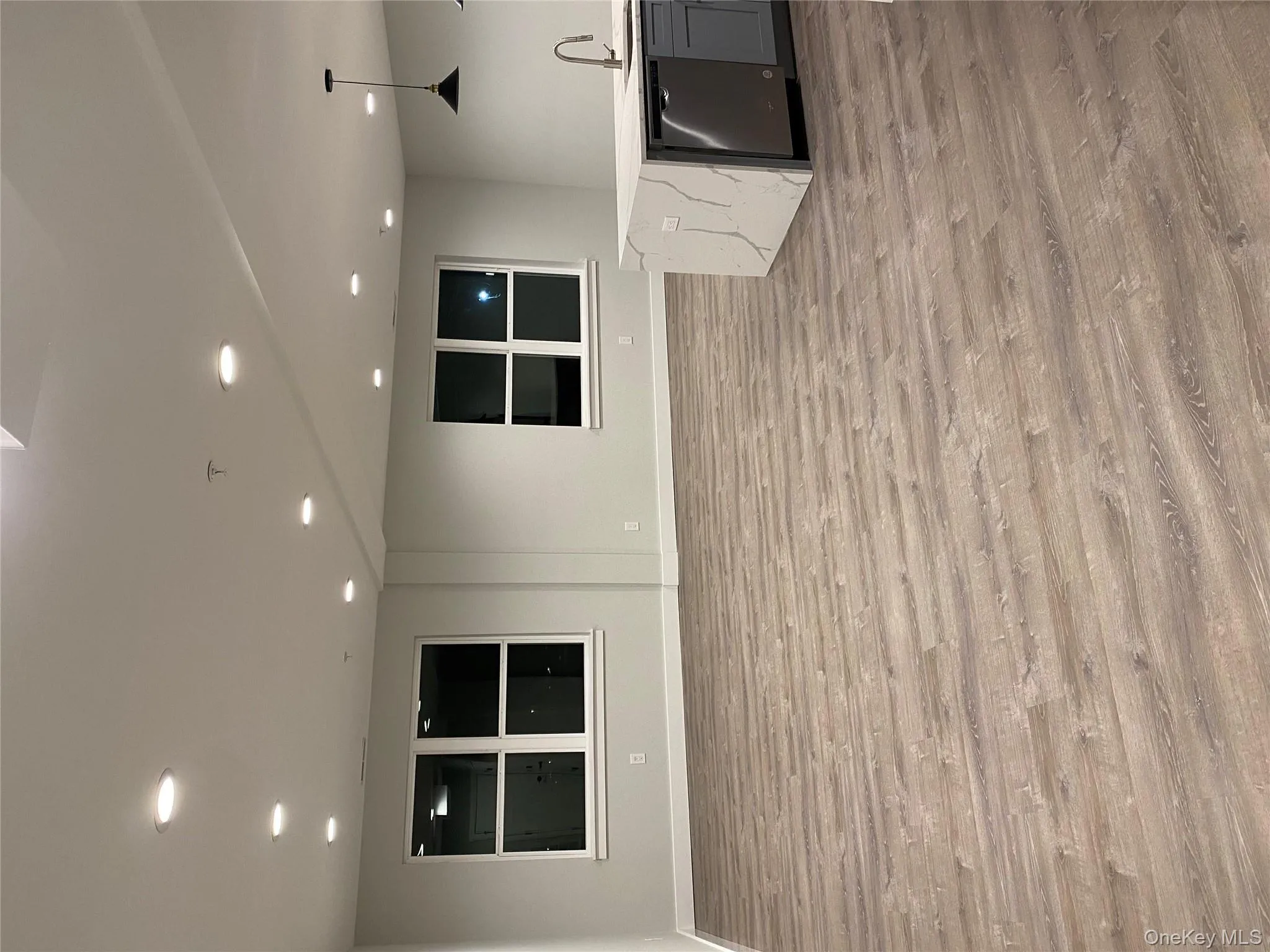 Kitchen with light wood-type flooring, open floor plan, recessed lighting, and dishwashing machine Kitchen with light wood-type flooring, open floor plan, recessed lighting, and dishwashing machine