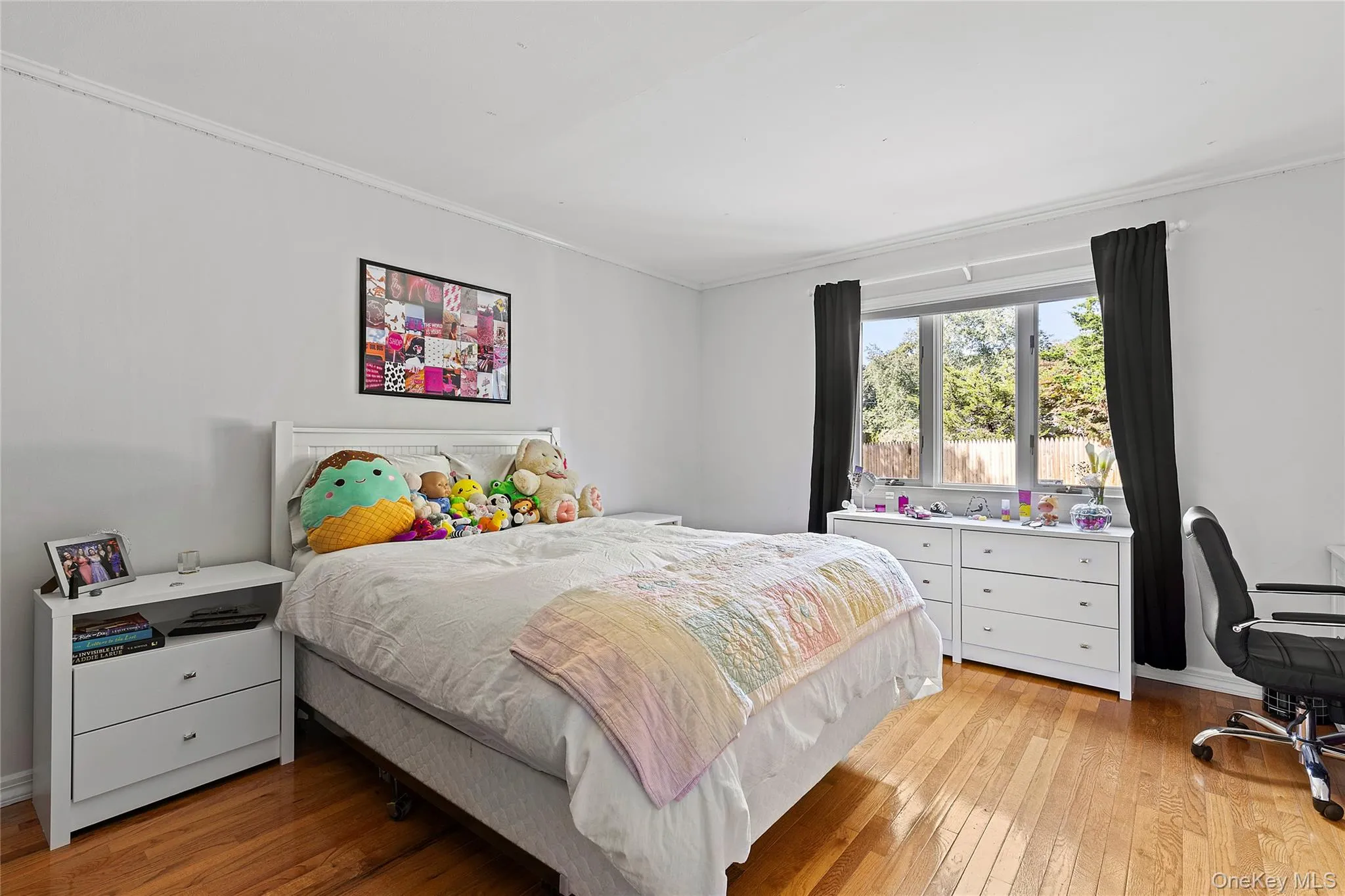 Bedroom with light wood-type flooring, ornamental molding, and a desk Bedroom with light wood-type flooring, ornamental molding, and a desk