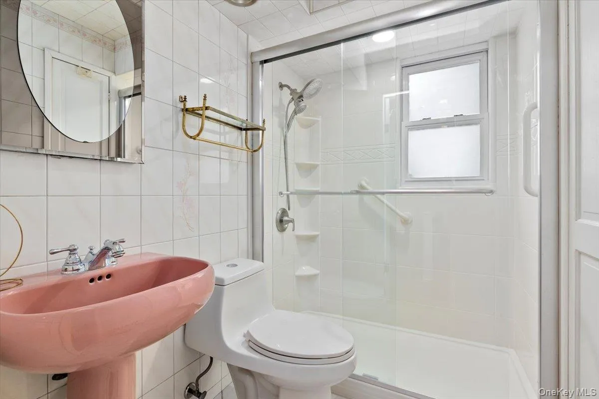 Bathroom featuring tile walls and a stall shower Bathroom featuring tile walls and a stall shower