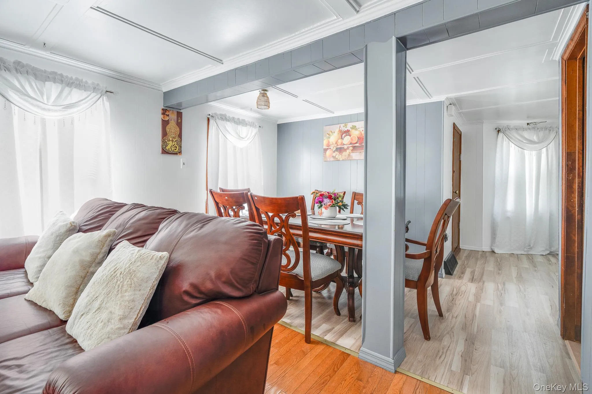 Dining area featuring light wood-style flooring and crown molding Dining area featuring light wood-style flooring and crown molding