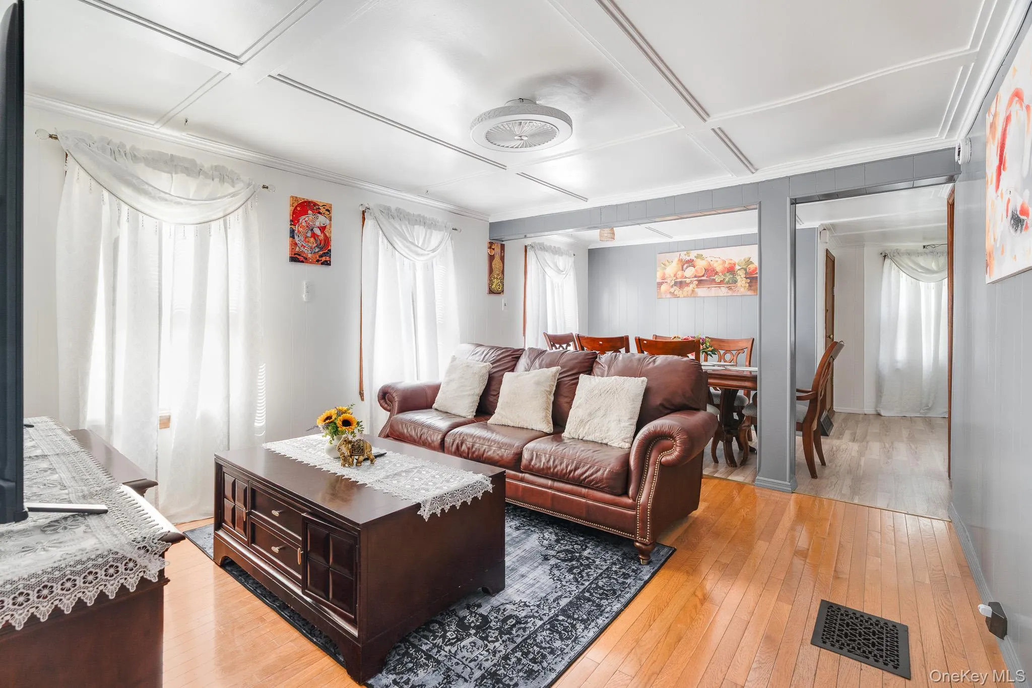 Living area with light wood-type flooring and coffered ceiling Living area with light wood-type flooring and coffered ceiling