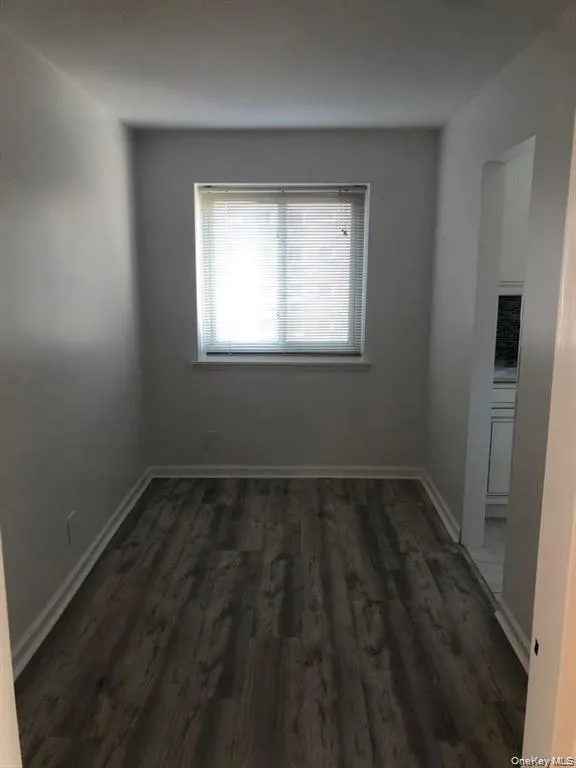 Spare room featuring dark wood finished floors and baseboards Spare room featuring dark wood finished floors and baseboards