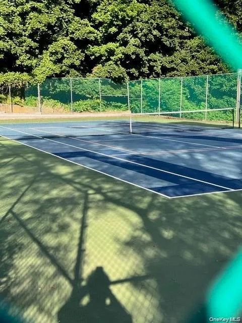 View of tennis court featuring community basketball court View of tennis court featuring community basketball court