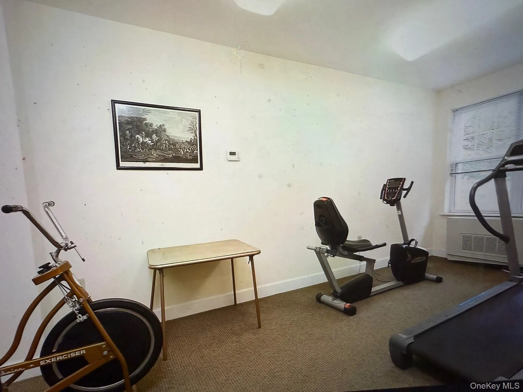 Exercise room featuring baseboards and carpet Exercise room featuring baseboards and carpet