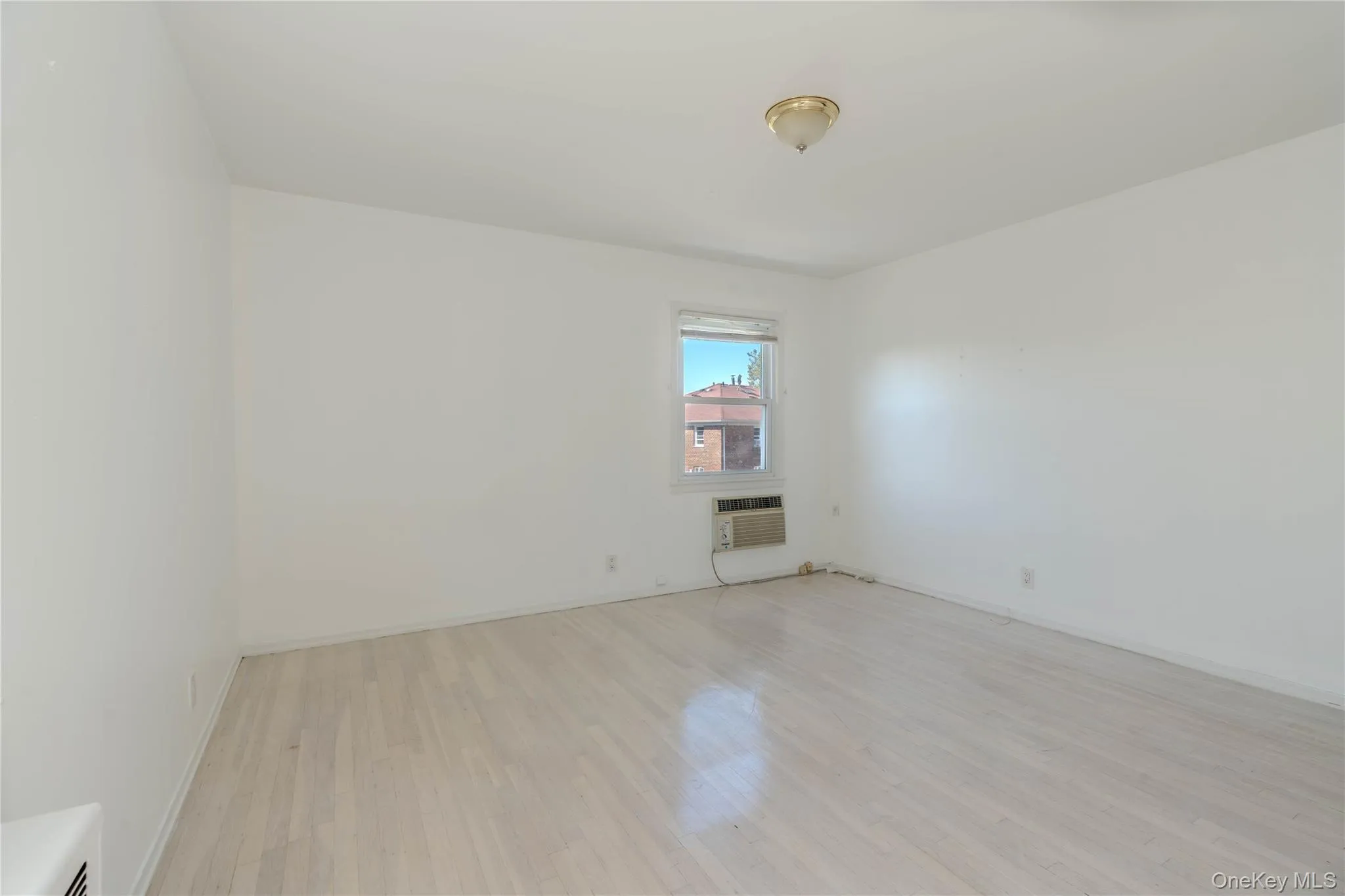 Unfurnished room featuring light wood finished floors and baseboards Unfurnished room featuring light wood finished floors and baseboards