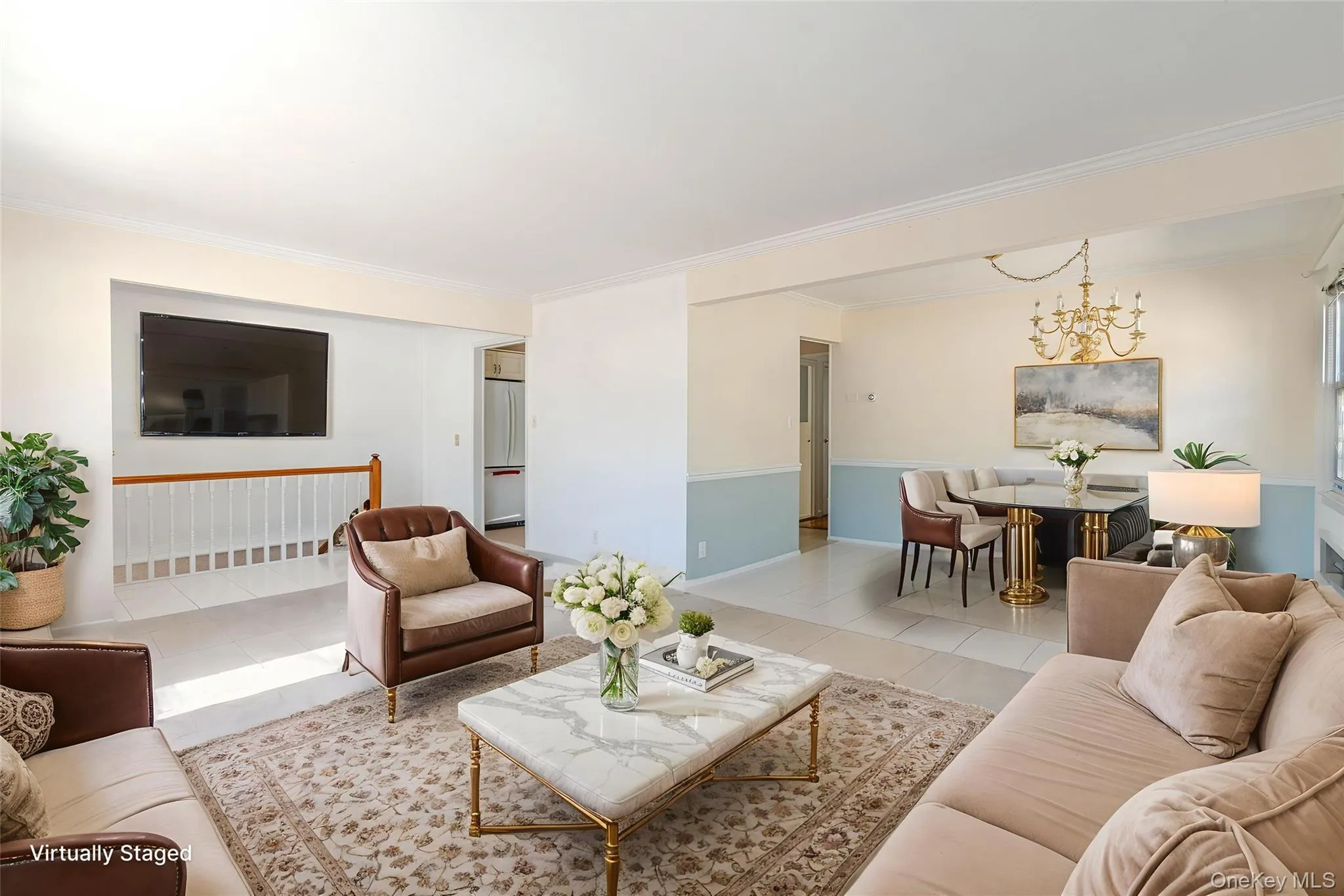 Living area featuring tile patterned flooring, crown molding, and a chandelier Living area featuring tile patterned flooring, crown molding, and a chandelier