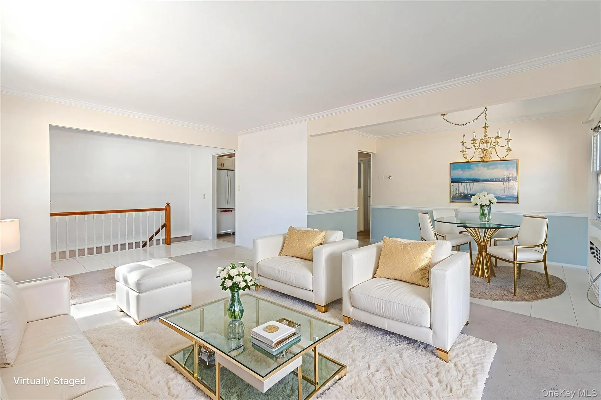Living area featuring ornamental molding, tile patterned flooring, and a chandelier Living area featuring ornamental molding, tile patterned flooring, and a chandelier