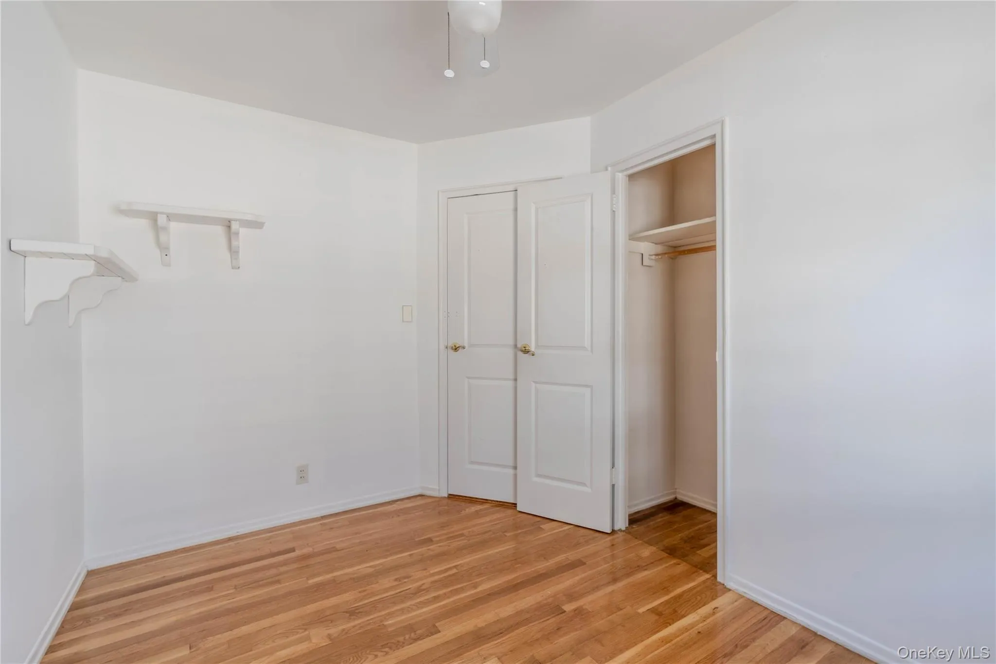 Unfurnished bedroom featuring light wood finished floors, a closet, and ceiling fan Unfurnished bedroom featuring light wood finished floors, a closet, and ceiling fan