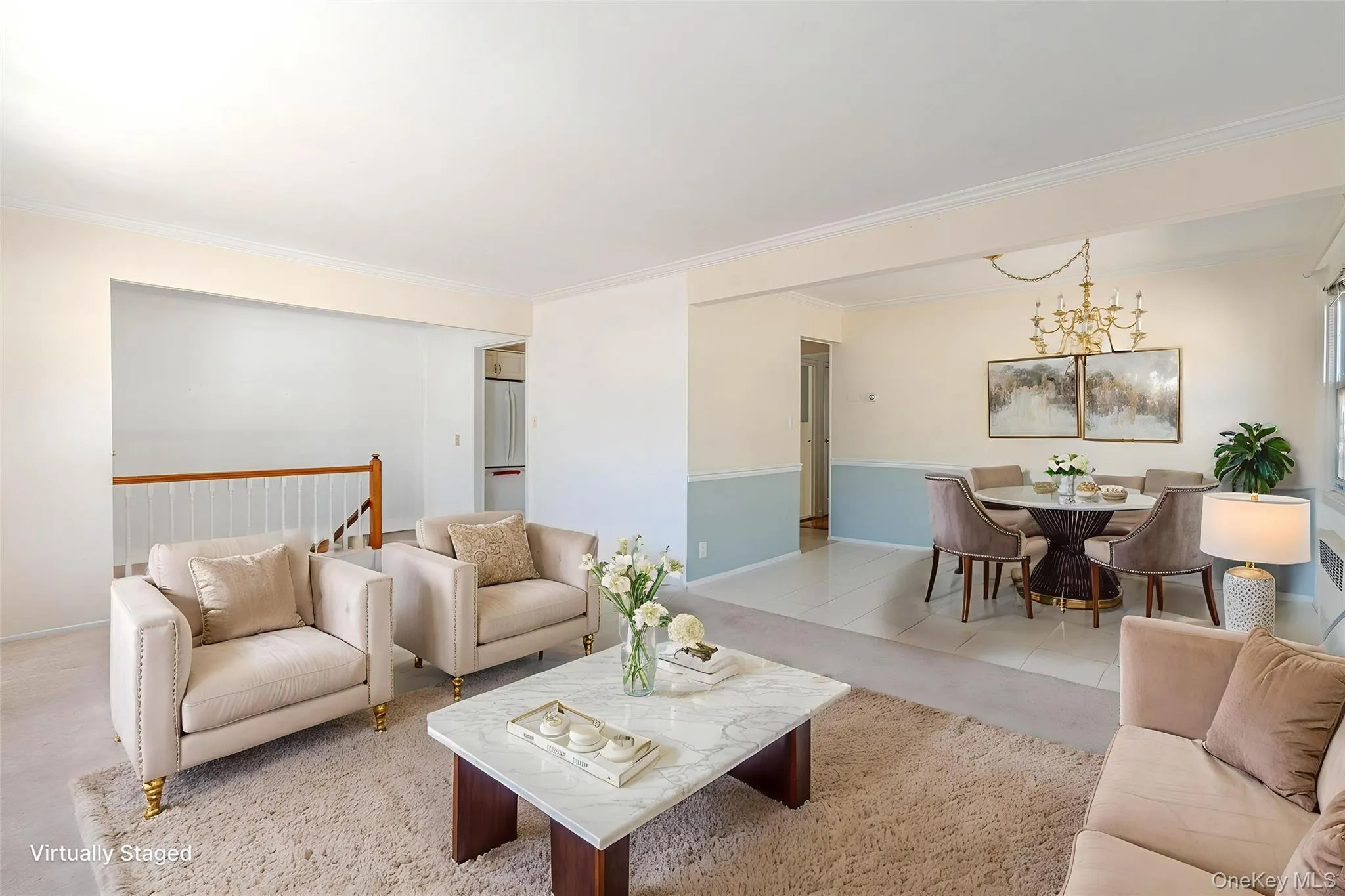 Tiled living room featuring crown molding and a chandelier Tiled living room featuring crown molding and a chandelier