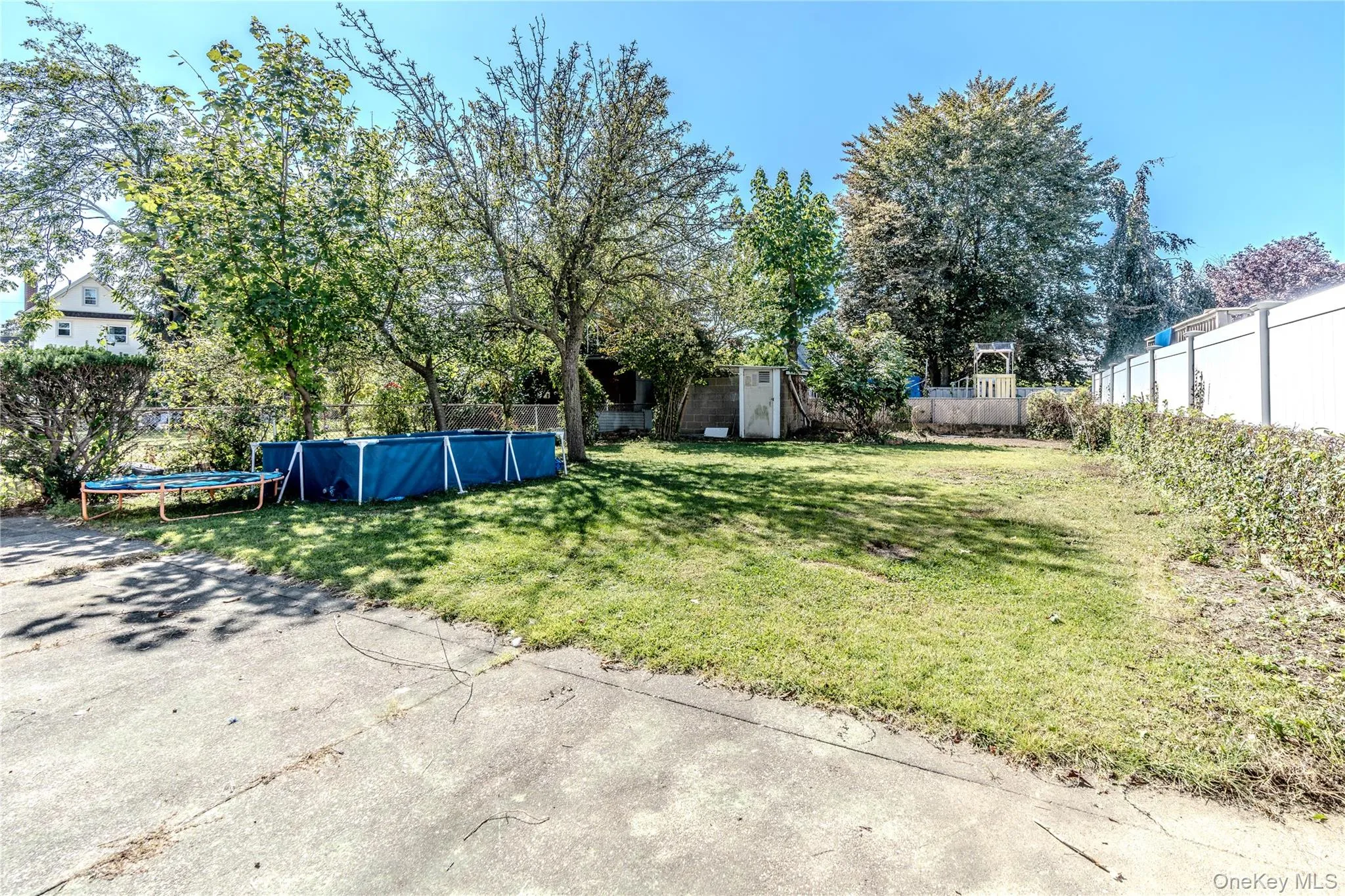 Fenced backyard featuring a trampoline Fenced backyard featuring a trampoline