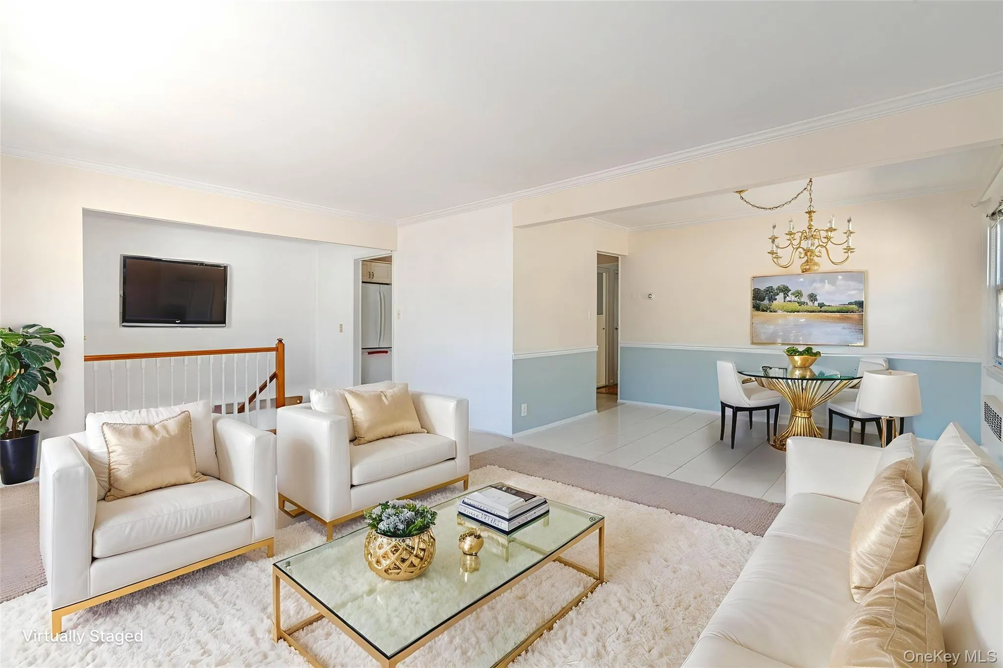 Tiled living area featuring a chandelier and ornamental molding Tiled living area featuring a chandelier and ornamental molding