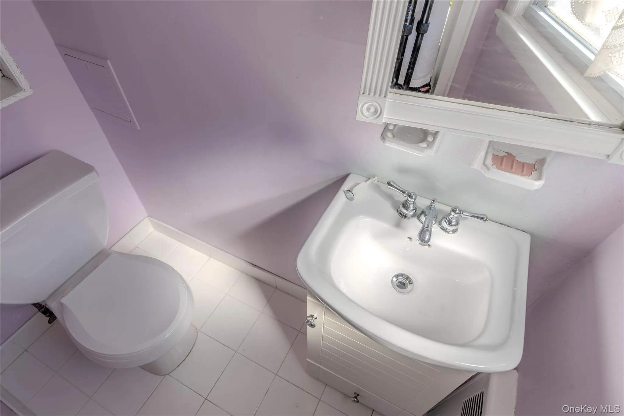 Half bath with toilet and tile patterned flooring Half bath with toilet and tile patterned flooring