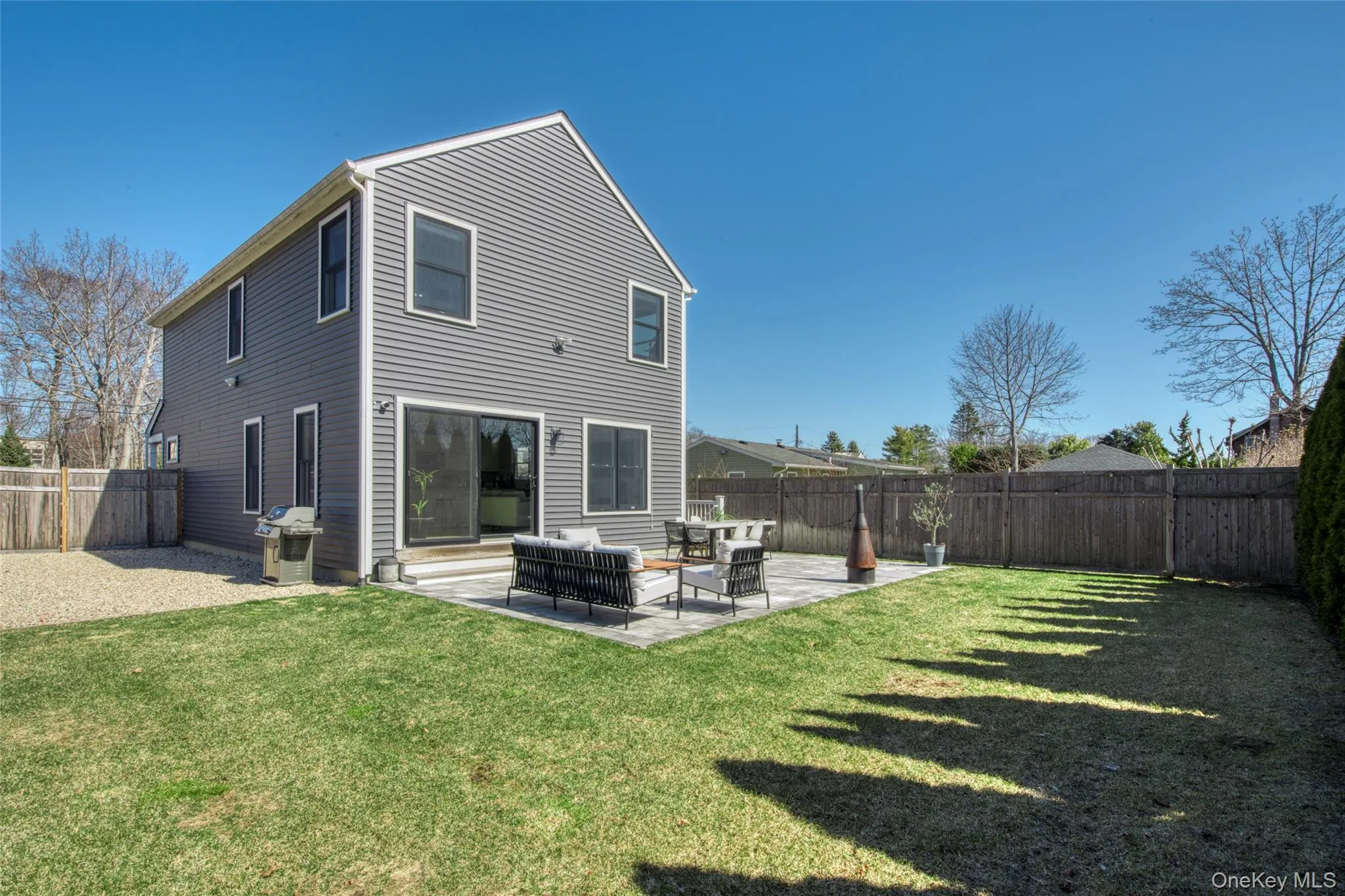 Back of house with an outdoor living space, a patio area, and a fenced backyard Back of house with an outdoor living space, a patio area, and a fenced backyard