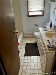 Bathroom with vanity and a baseboard heating unit Bathroom with vanity and a baseboard heating unit