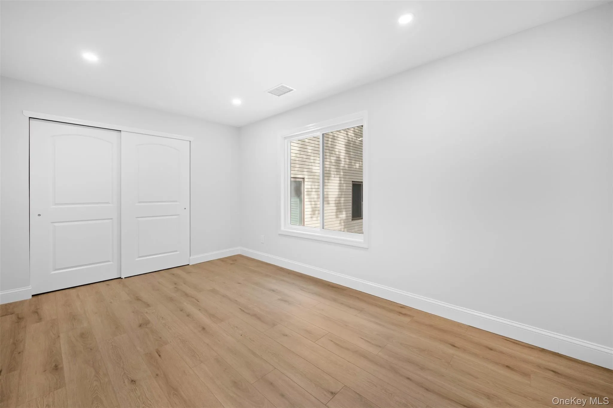 Unfurnished bedroom featuring light wood-style flooring, recessed lighting, and a closet Unfurnished bedroom featuring light wood-style flooring, recessed lighting, and a closet