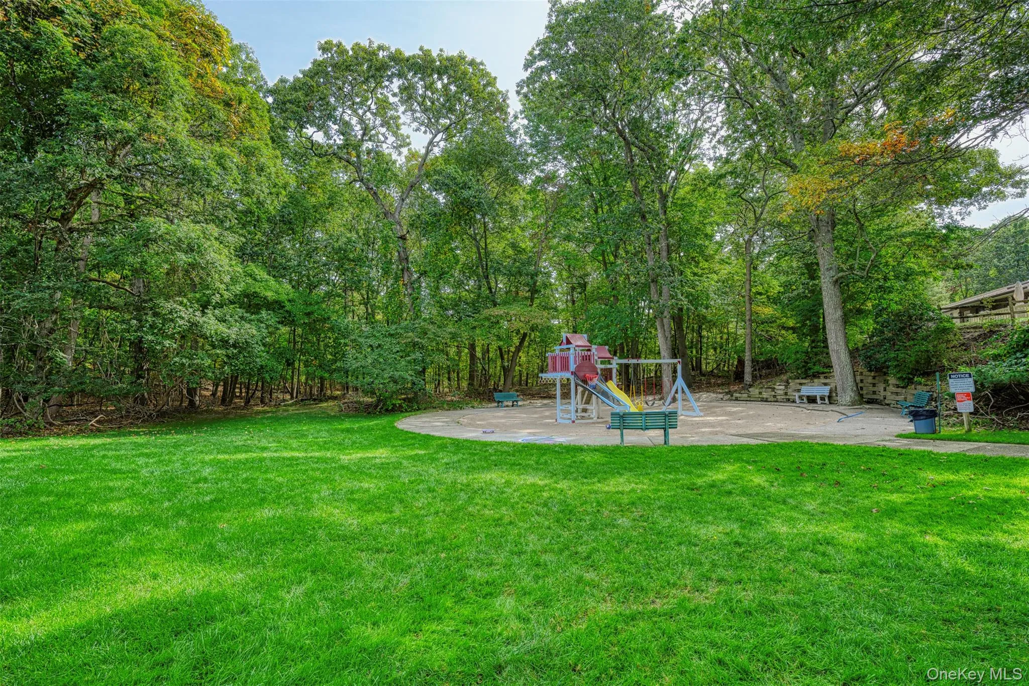 View of green lawn with a playground and a patio View of green lawn with a playground and a patio