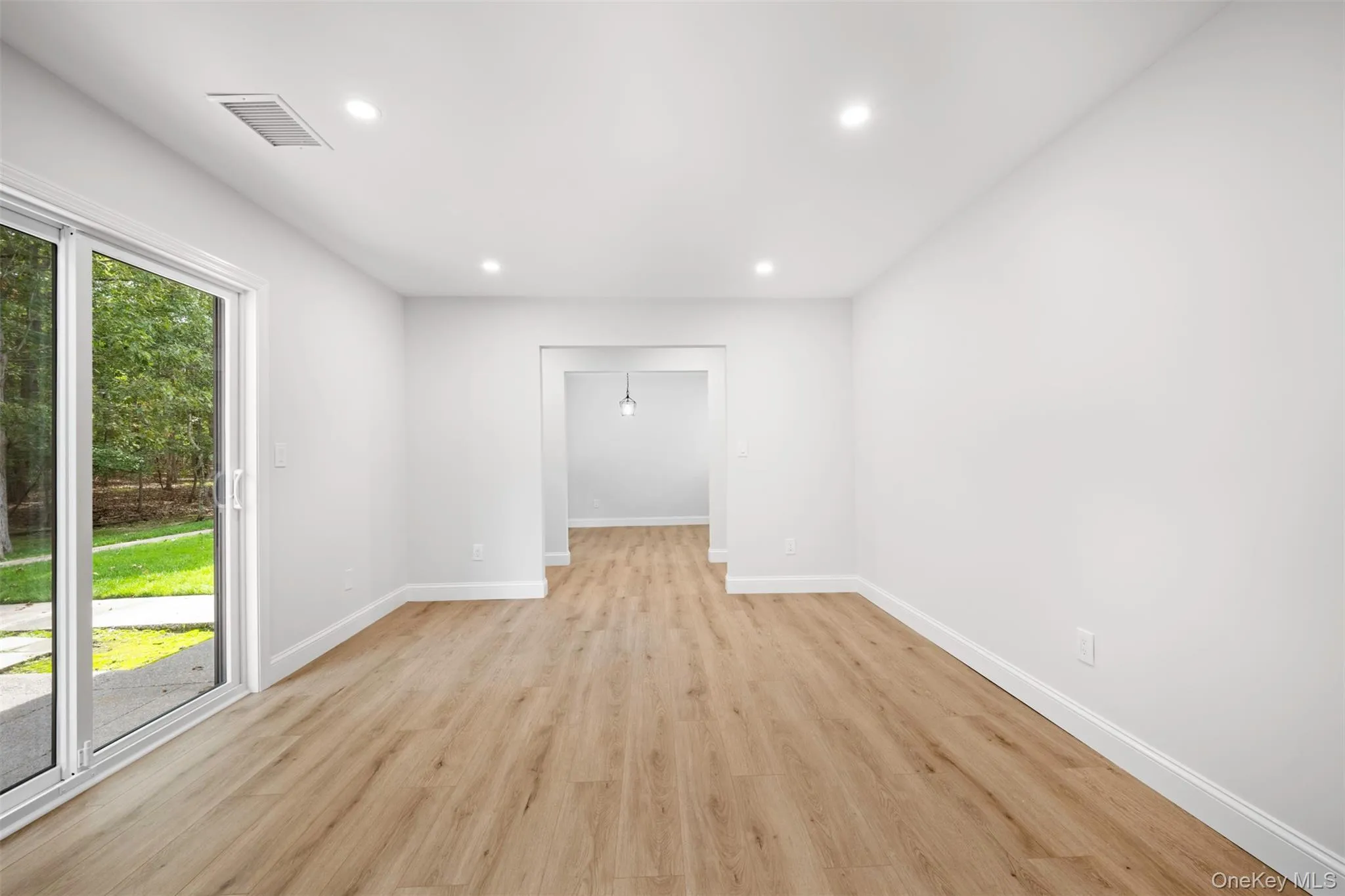 Empty room with light wood-style flooring and recessed lighting Empty room with light wood-style flooring and recessed lighting