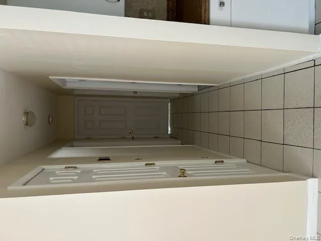 Hall with baseboards and light tile patterned flooring Hall with baseboards and light tile patterned flooring