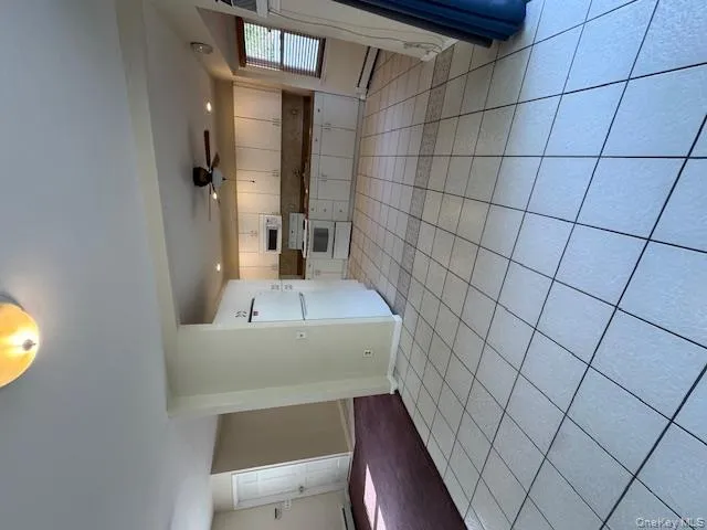 Kitchen featuring light tile patterned flooring, white cabinets, and recessed lighting Kitchen featuring light tile patterned flooring, white cabinets, and recessed lighting